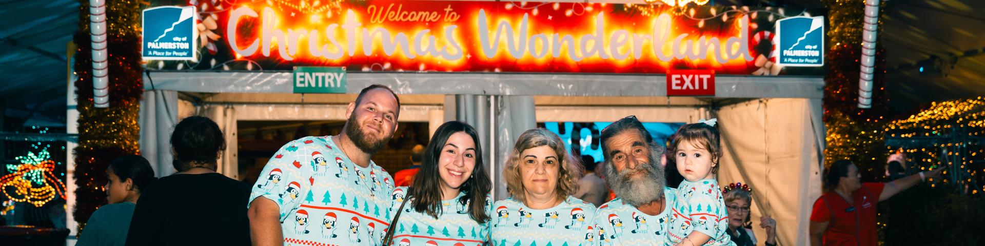 Image: family standing infront of Christmas Wonderland entry 