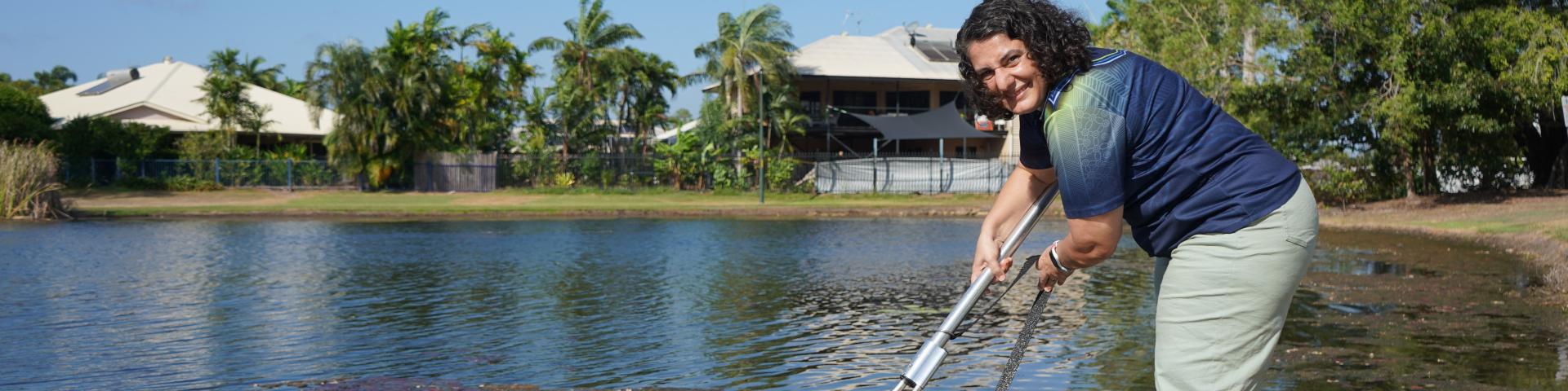 Mayor Athina Pascoe-Bell releasing fish into Lake 10