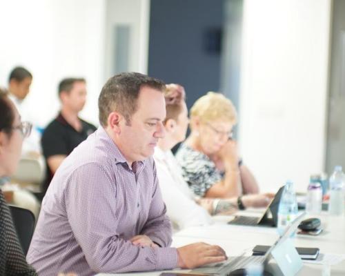 Photo of man in meeting concentrating 